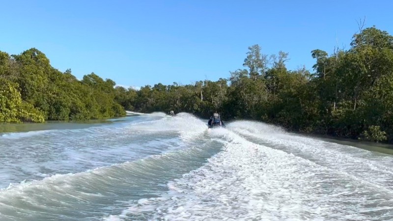 a man riding a wave on top of a body of water