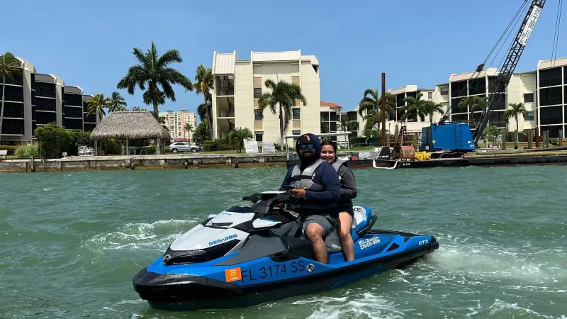 a man in a blue boat on a body of water