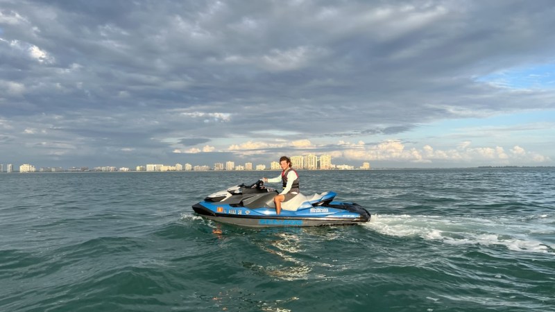 a person riding a surf board on a body of water