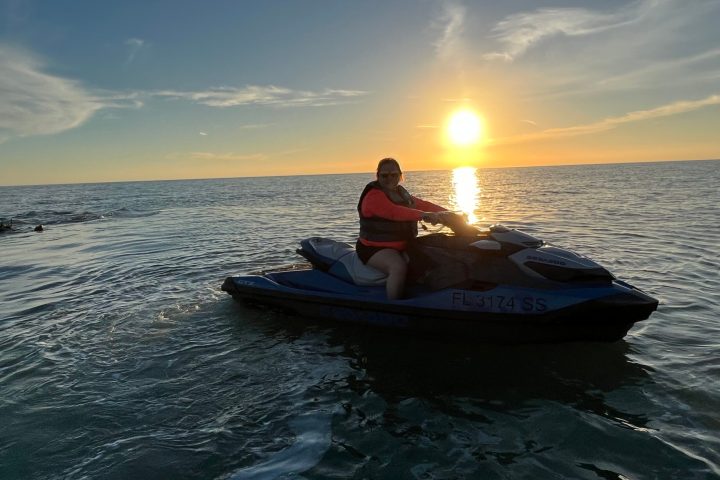 a man sitting in a boat on a body of water