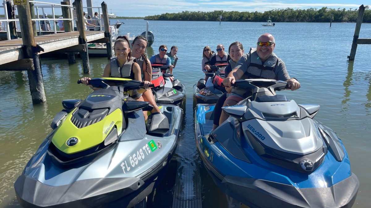 a group of people in a boat on a body of water